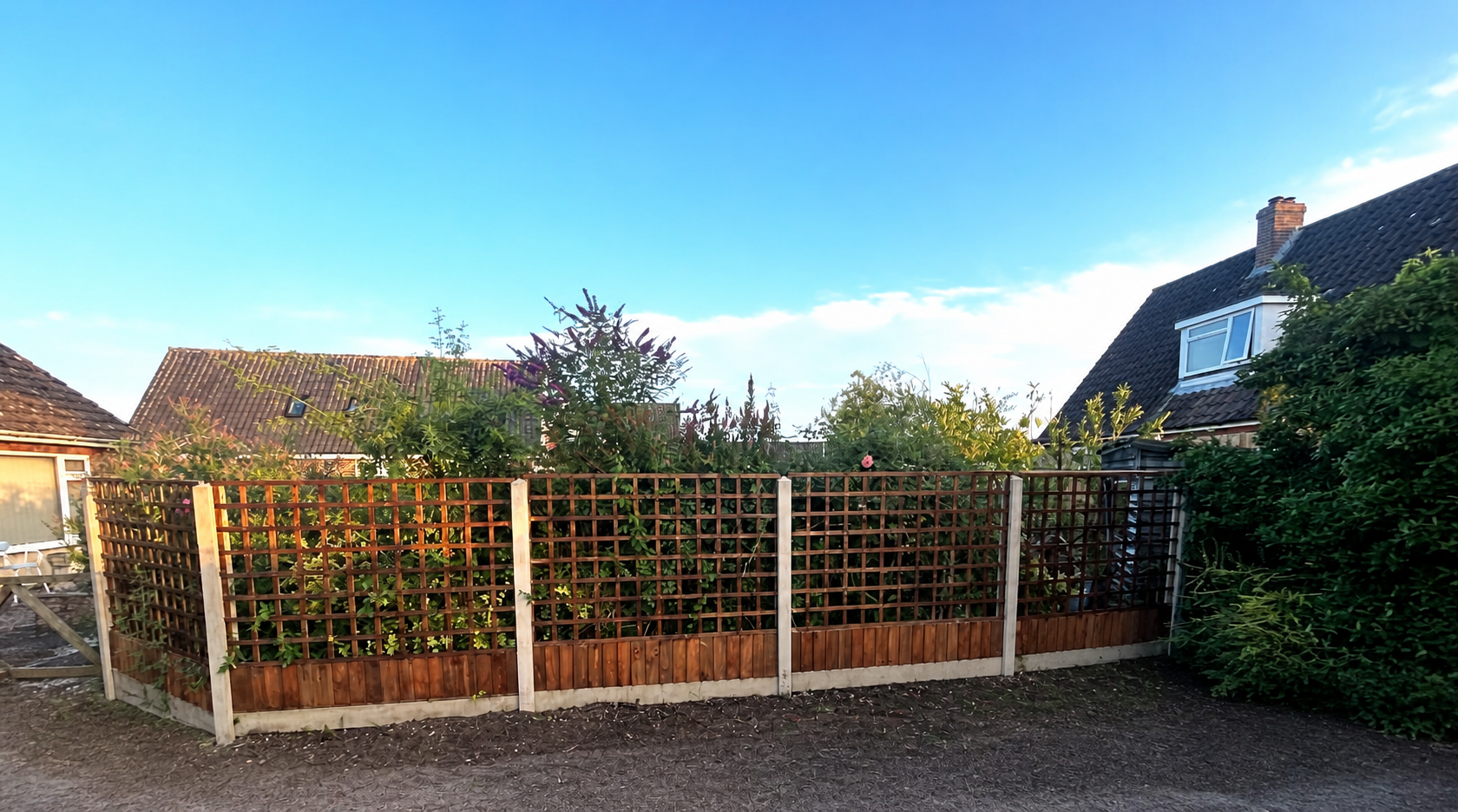 Custom timber trellis fencing around a garden